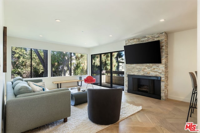 living room with a fireplace and light parquet floors