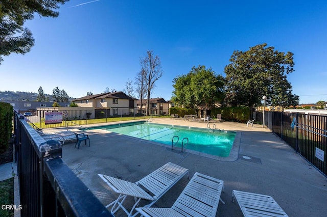 pool featuring a patio area and fence