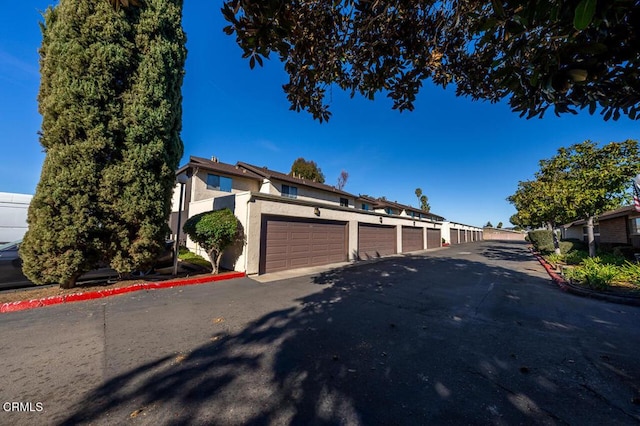 view of front of house with community garages and stucco siding