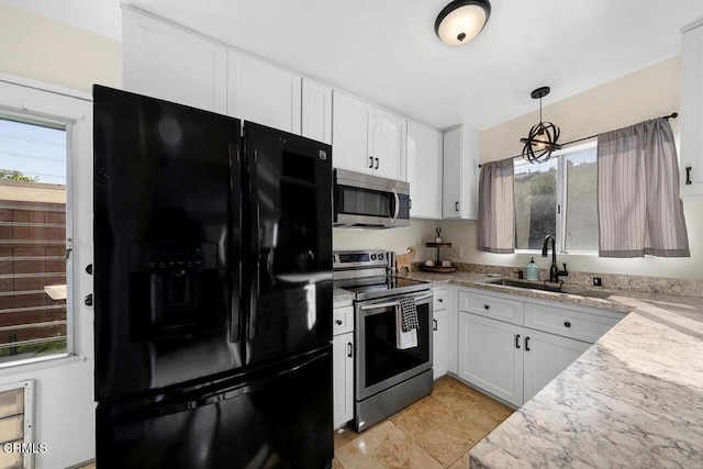 kitchen with white cabinetry, pendant lighting, appliances with stainless steel finishes, and a sink