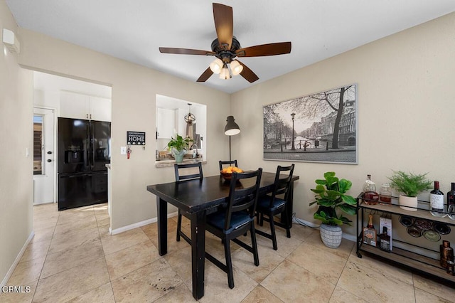 dining area with baseboards, light tile patterned floors, and a ceiling fan
