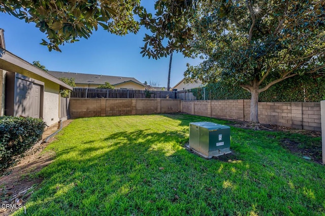 view of yard with a fenced backyard