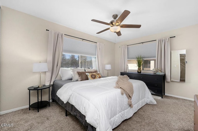carpeted bedroom featuring baseboards and a ceiling fan