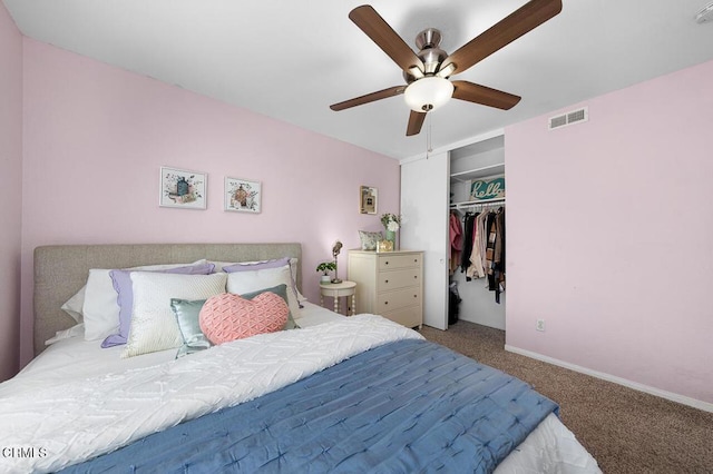 carpeted bedroom featuring a closet, baseboards, ceiling fan, and visible vents