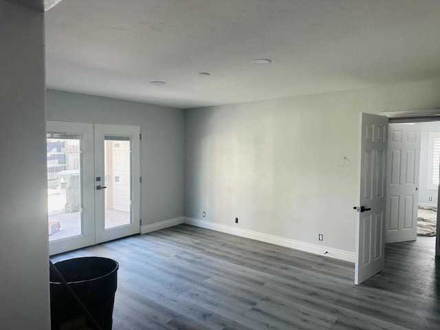 spare room with french doors and hardwood / wood-style flooring