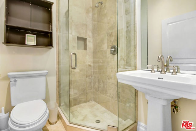 bathroom with walk in shower and toilet