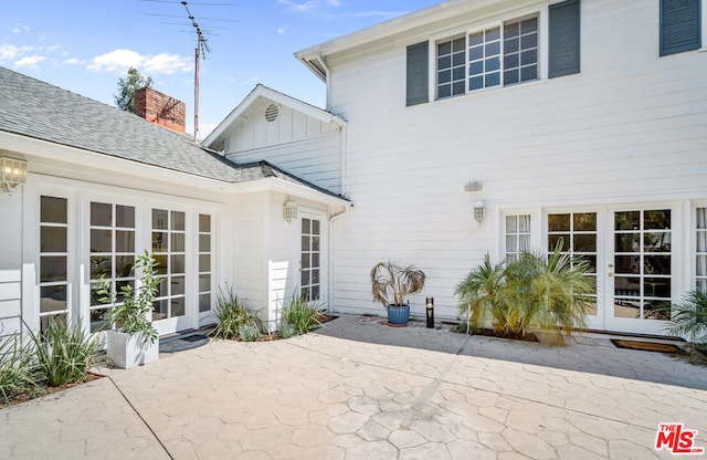 rear view of house with french doors and a patio area