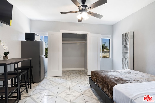 bedroom featuring stainless steel refrigerator and ceiling fan