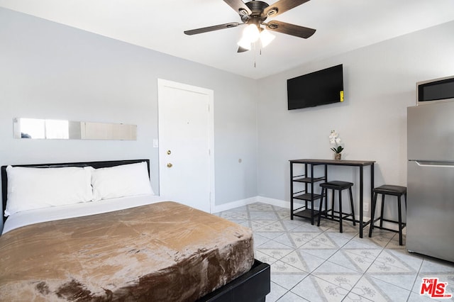 bedroom featuring stainless steel fridge and ceiling fan