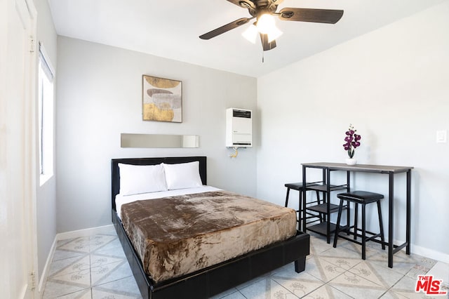 bedroom with multiple windows, heating unit, and ceiling fan