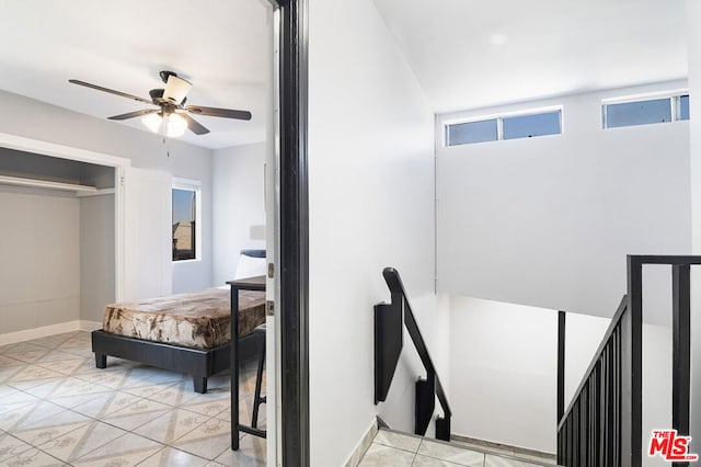 interior space with ceiling fan and a closet