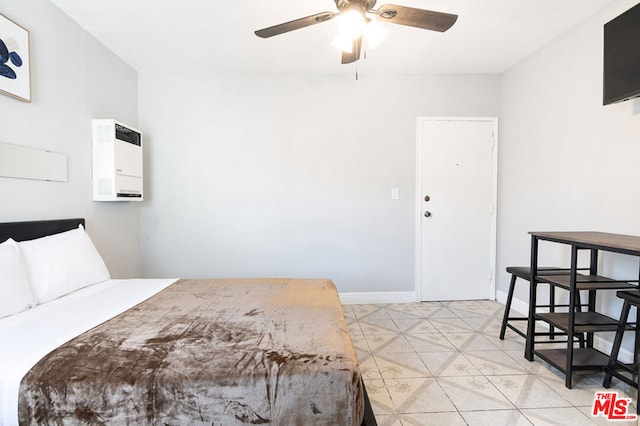 tiled bedroom featuring ceiling fan