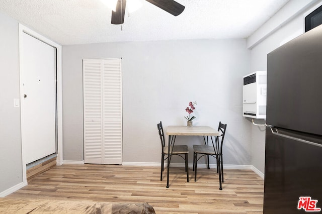 dining room with ceiling fan and light hardwood / wood-style flooring