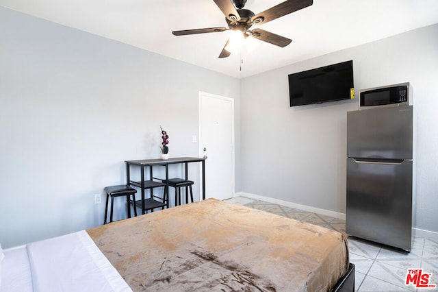 tiled bedroom with stainless steel fridge and ceiling fan