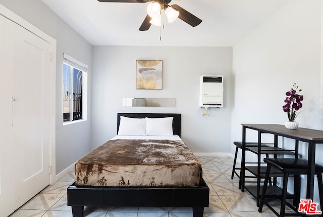 bedroom with heating unit and ceiling fan