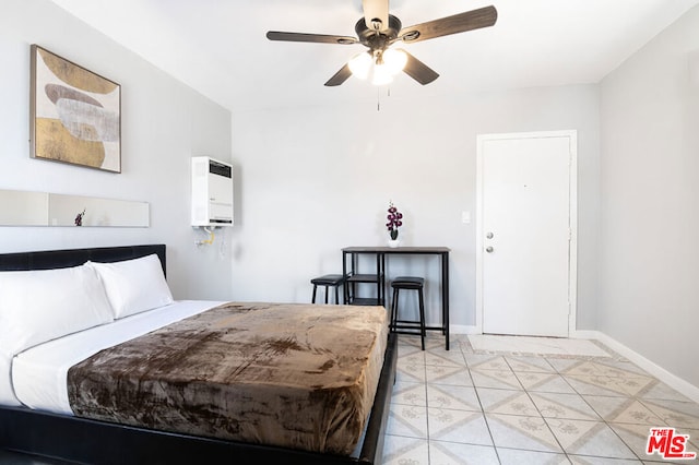 bedroom with ceiling fan and light tile patterned flooring