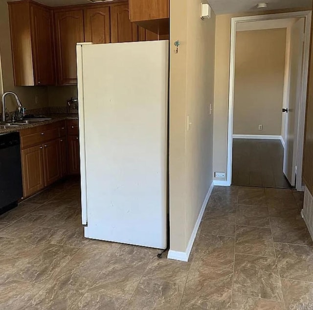 kitchen with black dishwasher, sink, and white refrigerator