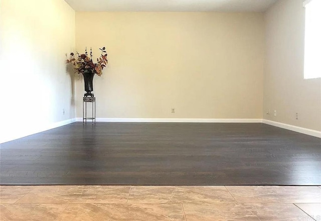 spare room with wood-type flooring