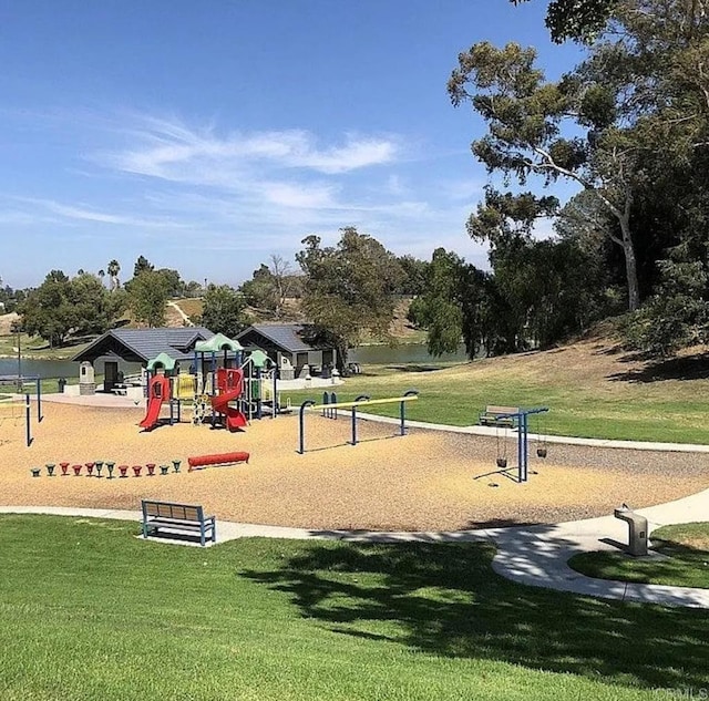 view of home's community featuring a playground and a yard