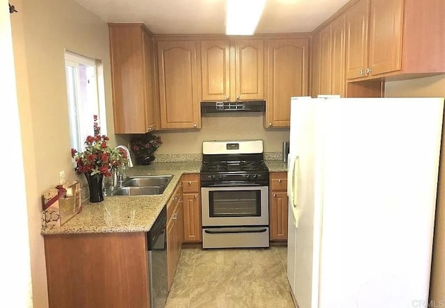 kitchen featuring dishwasher, white refrigerator, sink, gas range, and light stone countertops