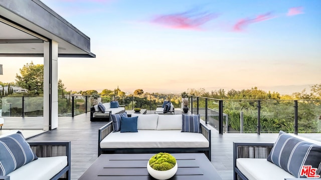 deck at dusk with an outdoor living space