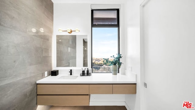 bathroom featuring tile walls and vanity