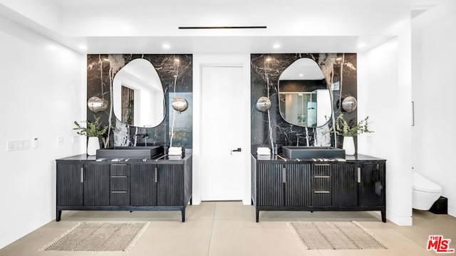 bathroom with toilet, tile patterned floors, and vanity