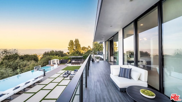 balcony at dusk with an outdoor living space