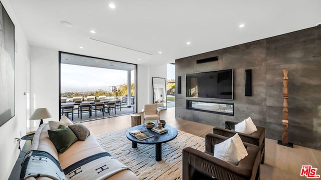 living room featuring floor to ceiling windows and light hardwood / wood-style floors