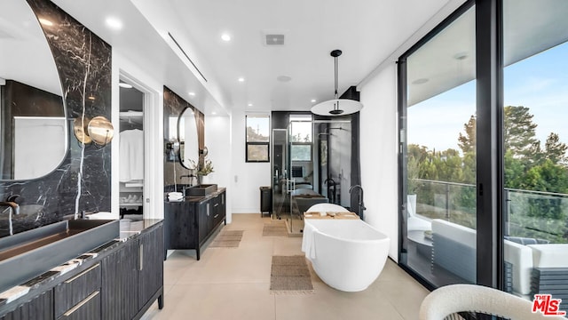 bathroom with separate shower and tub, vanity, tile patterned floors, and expansive windows