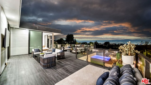 deck at dusk featuring an outdoor living space