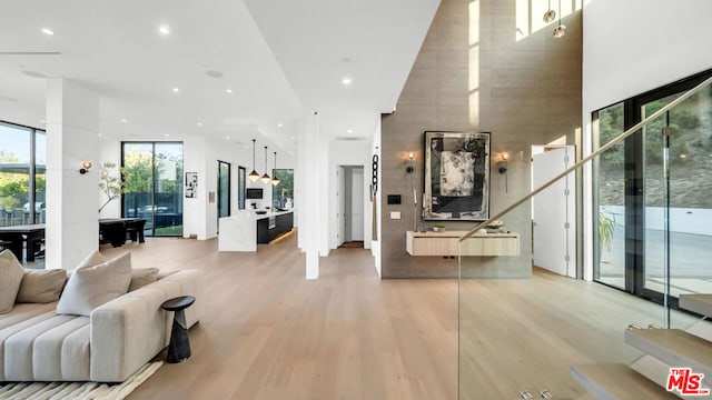 interior space featuring a wall of windows and light hardwood / wood-style flooring