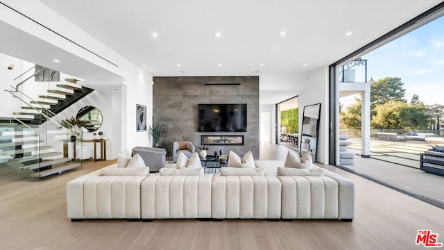 living room with floor to ceiling windows and light hardwood / wood-style flooring