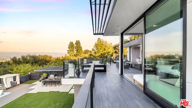 balcony at dusk featuring outdoor lounge area