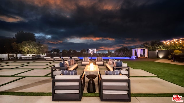 view of patio with an outdoor living space with a fire pit and a storage shed