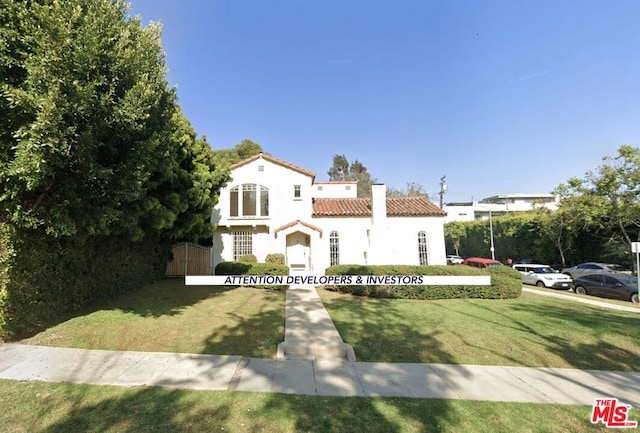 mediterranean / spanish-style house with a front yard