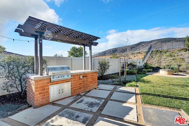 view of patio featuring a mountain view, area for grilling, and a grill