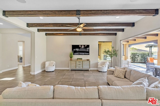 living room featuring beamed ceiling and ceiling fan