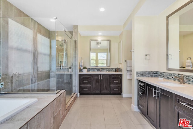 bathroom featuring tasteful backsplash, vanity, and independent shower and bath