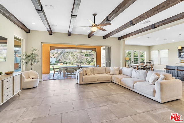 living room with beamed ceiling and ceiling fan