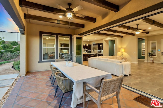 patio terrace at dusk featuring outdoor lounge area and ceiling fan