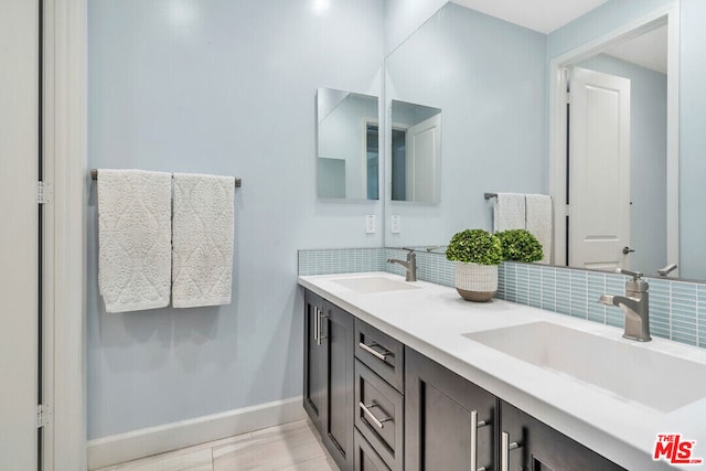 bathroom featuring tile patterned floors, decorative backsplash, and vanity