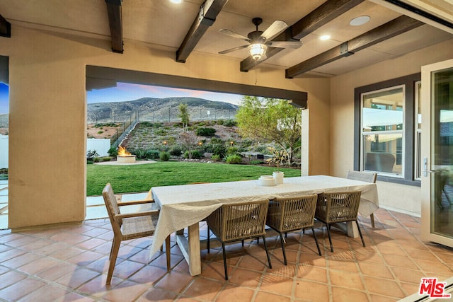 view of patio / terrace featuring a mountain view and ceiling fan