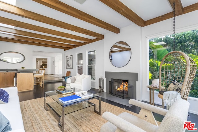 living room featuring beamed ceiling and hardwood / wood-style flooring