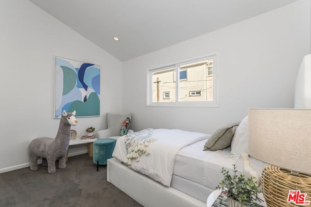 carpeted bedroom with vaulted ceiling