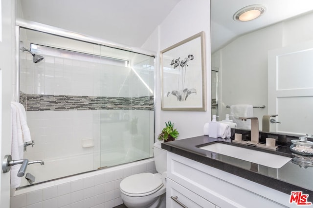 full bathroom with vanity, toilet, vaulted ceiling, and enclosed tub / shower combo