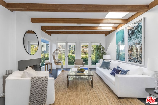 sunroom featuring beamed ceiling and french doors