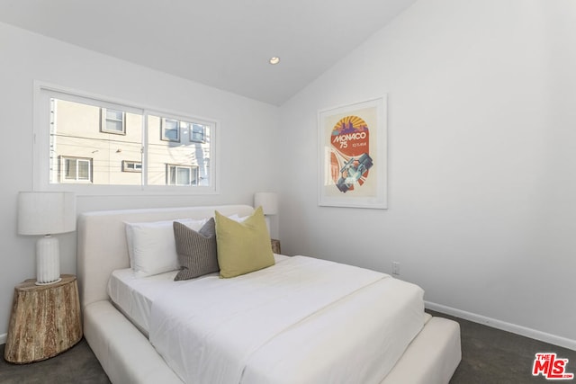 carpeted bedroom with vaulted ceiling