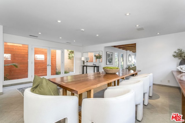 dining space featuring french doors, light tile patterned floors, and a wealth of natural light