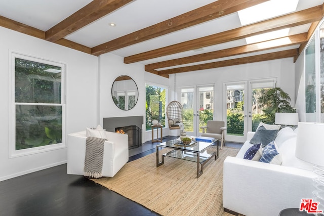 living room with beam ceiling, wood-type flooring, and french doors